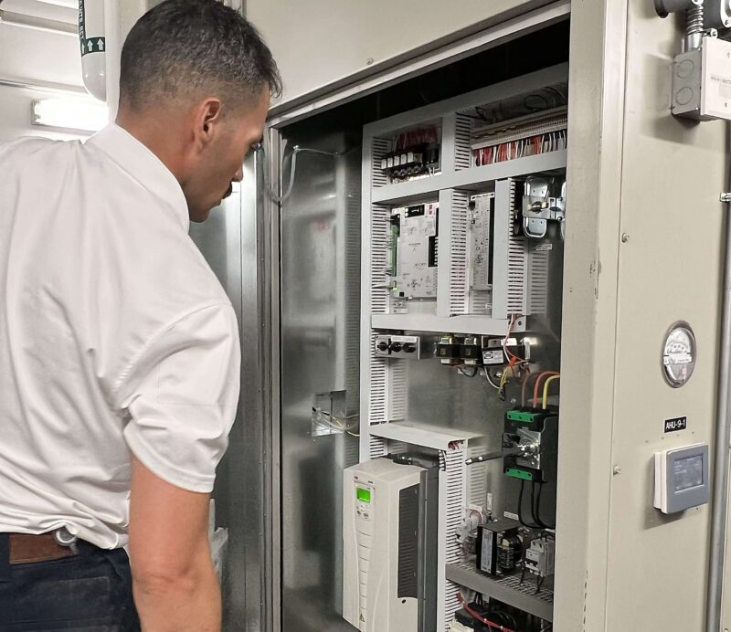 Employee checking hvac Employee checking hvac